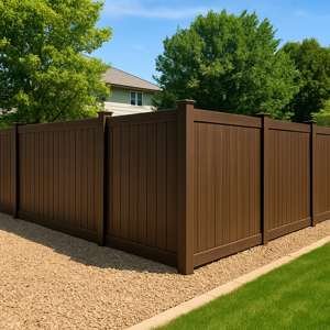 Composite Fence Installation Camas Brown composite fence installed in yard with decorative gravel in Camas, Wa.